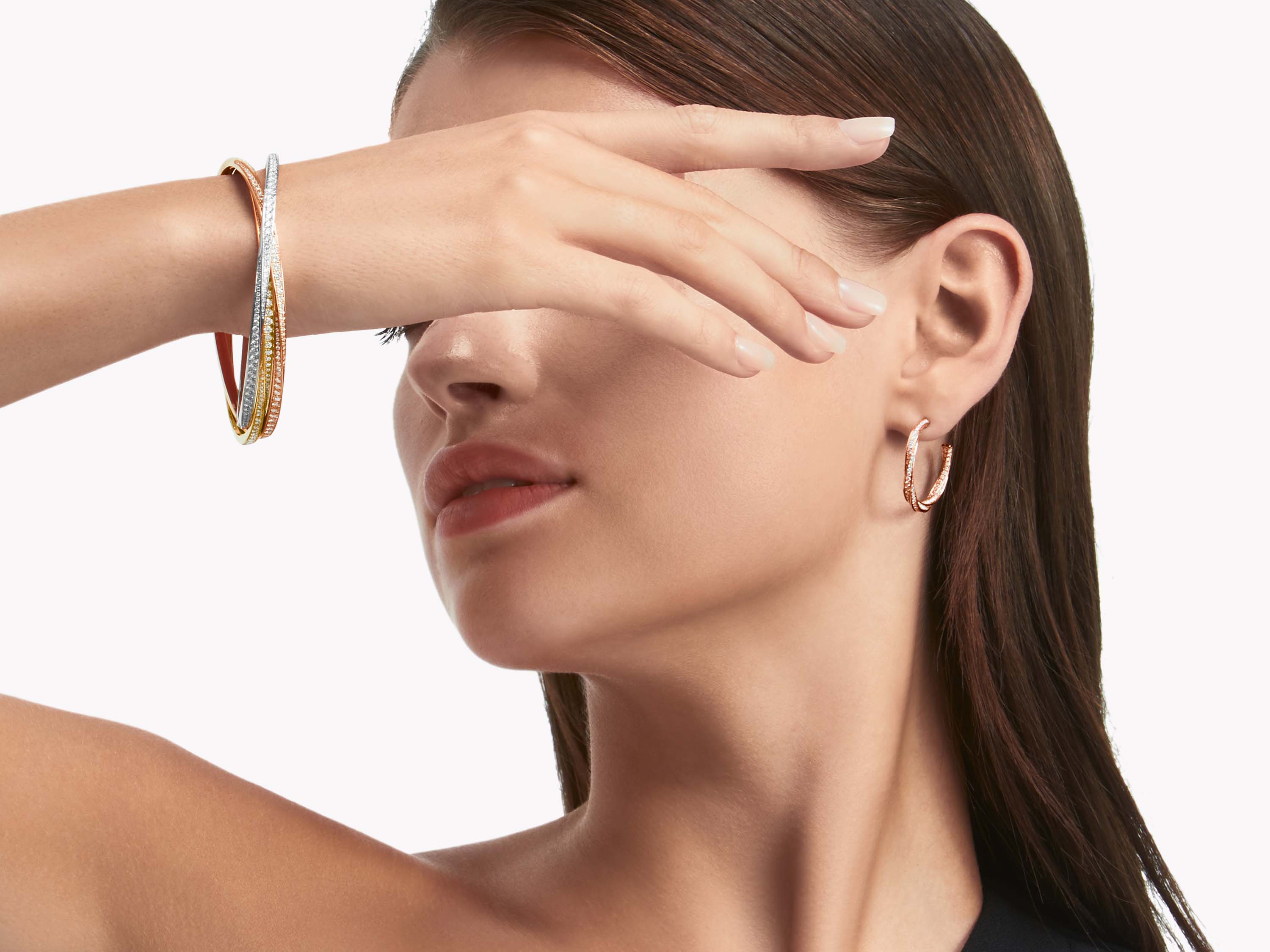 Model wearing Triple Spiral Pavé Diamond Bangle WHITE, YELLOW AND ROSE GOLD and Graff Spiral Diamond Hoop Earrings ROSE GOLD
