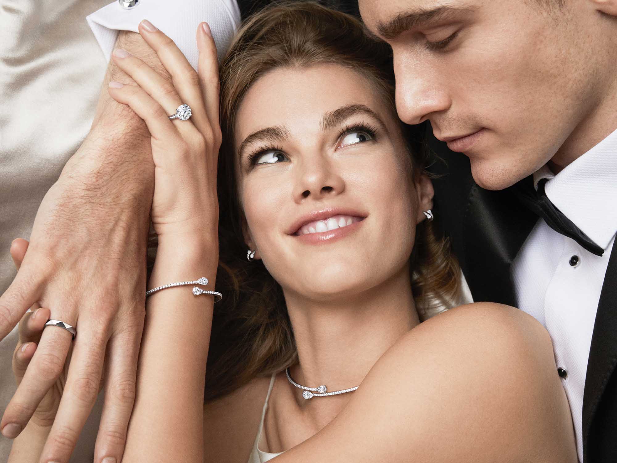 Bride wears Graff Duet jewellery collection necklace, ring, bracelet and round diamond solitaire and groom wears Laurence Graff signature white gold ring.