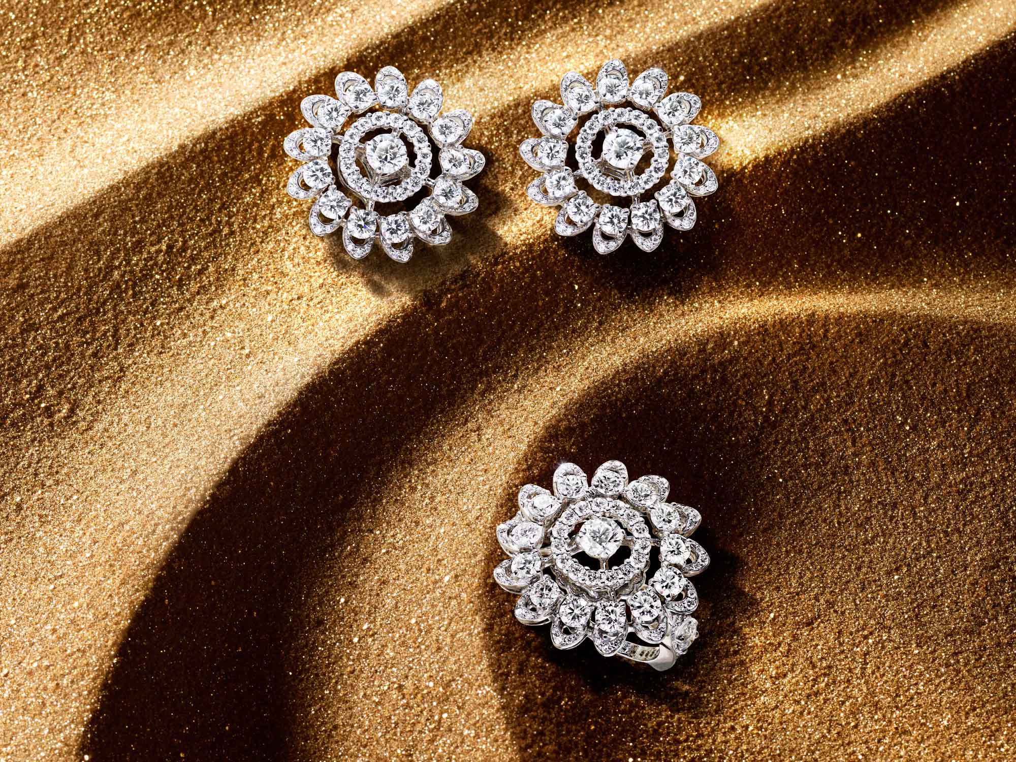 The Graff Gateway diamond earrings and ring from the Tribal jewellery collection, on sand