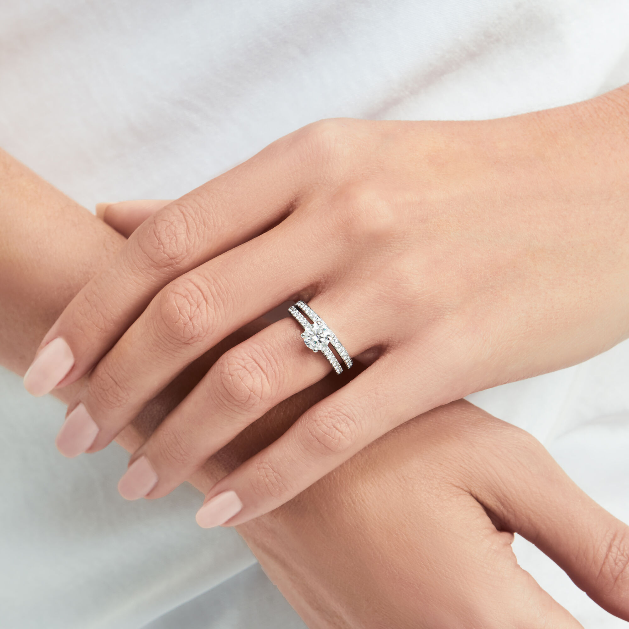 Close up of a model' hand wearing a Flame Round Diamond Engagement Ring from the Graff bridal jewellery collection