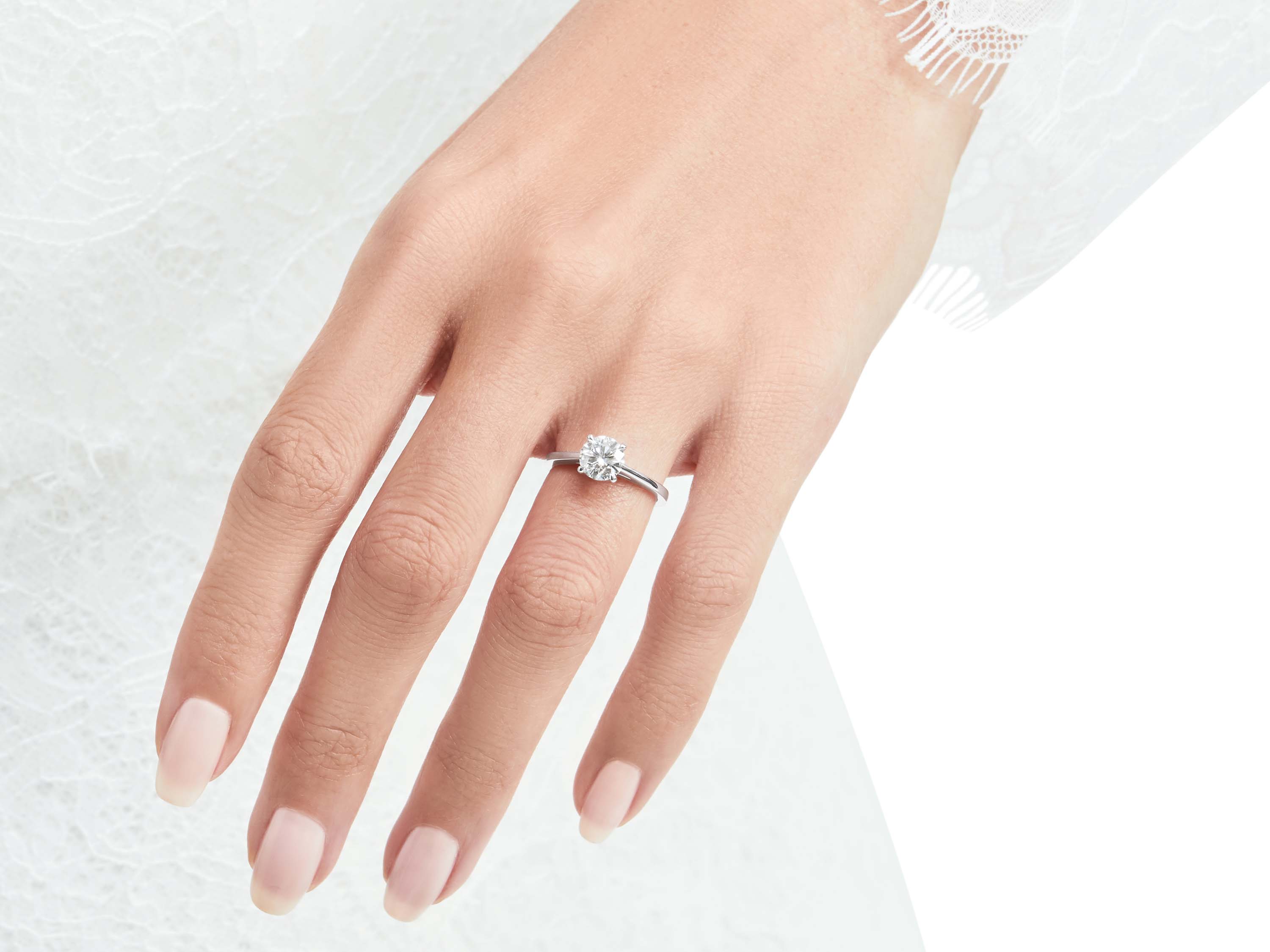 Model wears Paragon Round Diamond Engagement Ring from the Graff bridal jewellery collection
