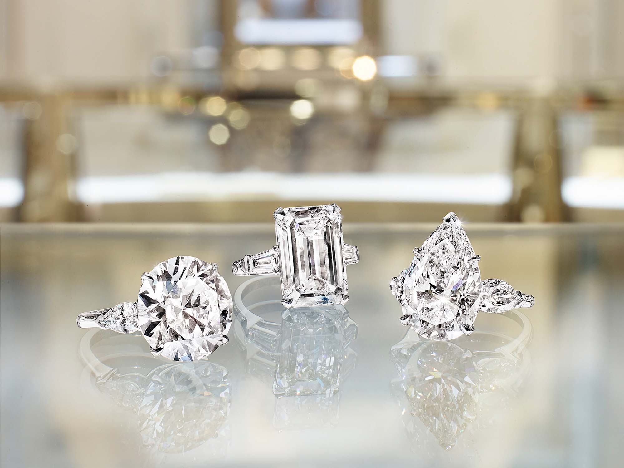 Three Graff Promise Engagement rings set with round diamond, pear Shape Diamond and Emerald Cut Diamond.